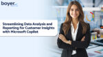 Woman with data charts, showcasing Microsoft Copilot for data analysis and reporting. Boyer & Associates empowers data-driven insights.